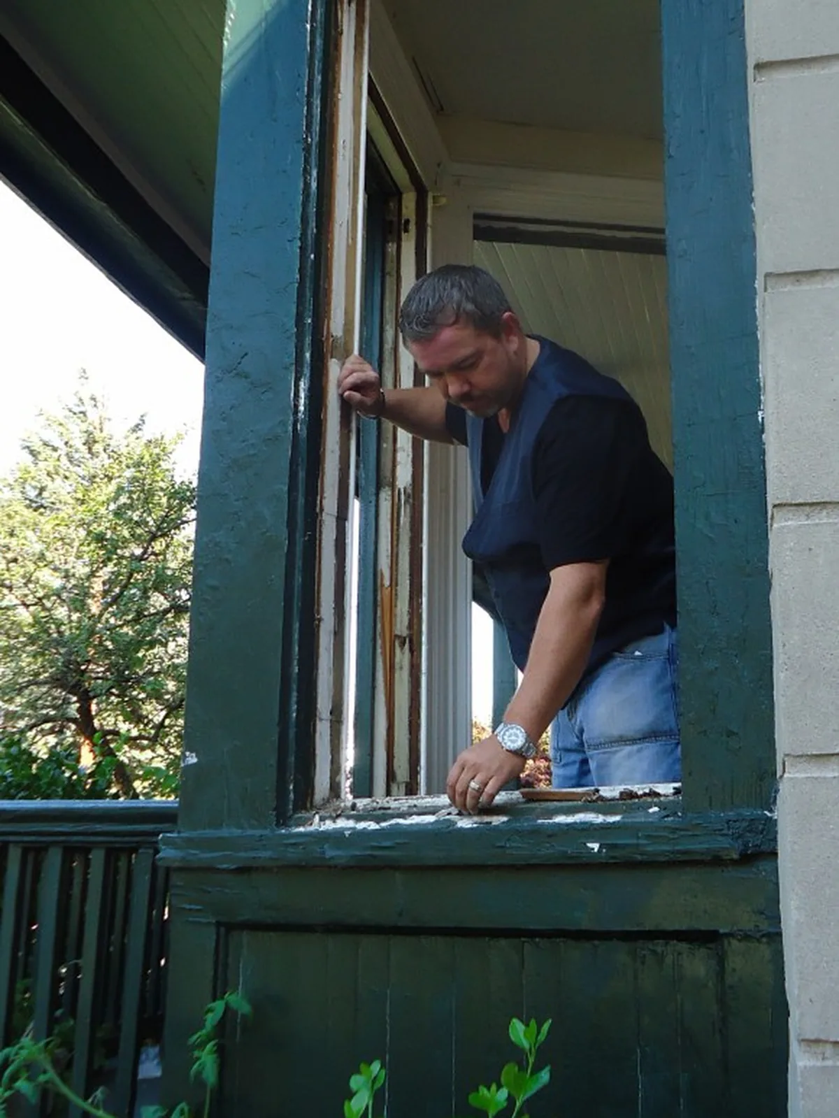 The work a window replacement cost in McDonough GA actually buys: an installer at the opening with the old sash out