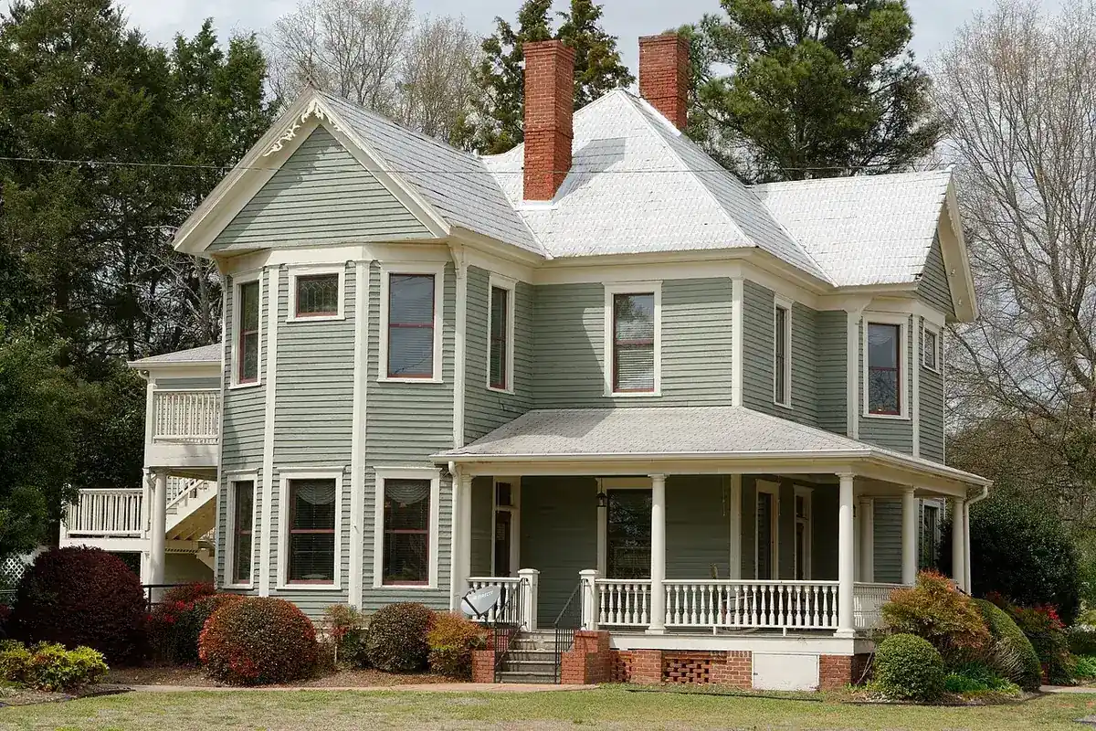 A green two-story Victorian house in the Locust Grove historic district, Georgia