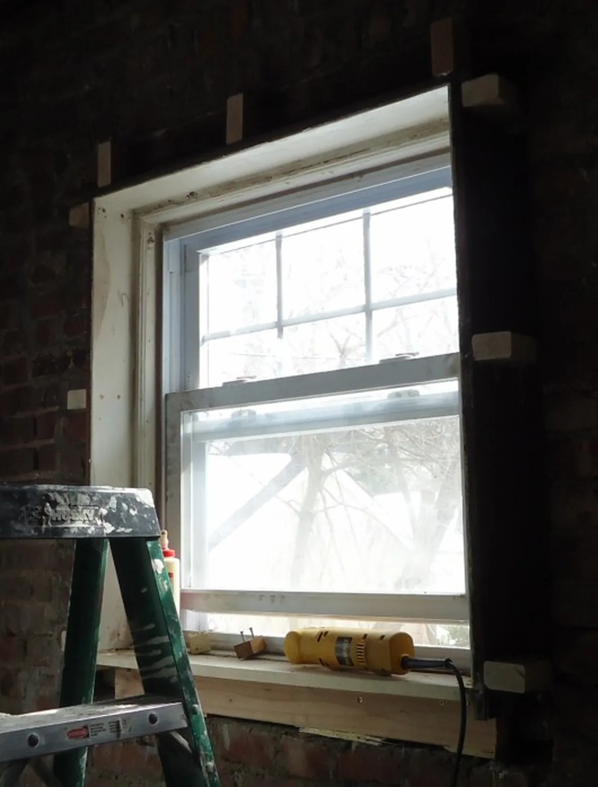 An old window opening in a McDonough GA house stripped back to bare framing, past the point where window repair pays